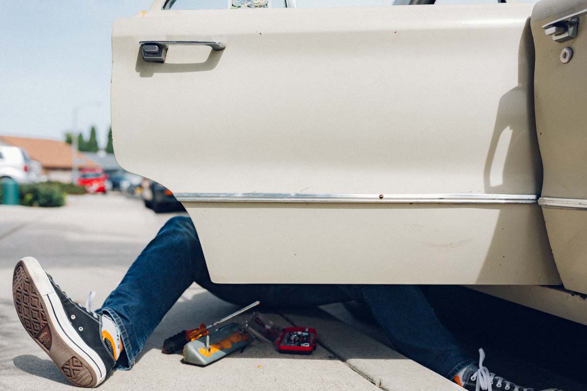 converse working on vintage car