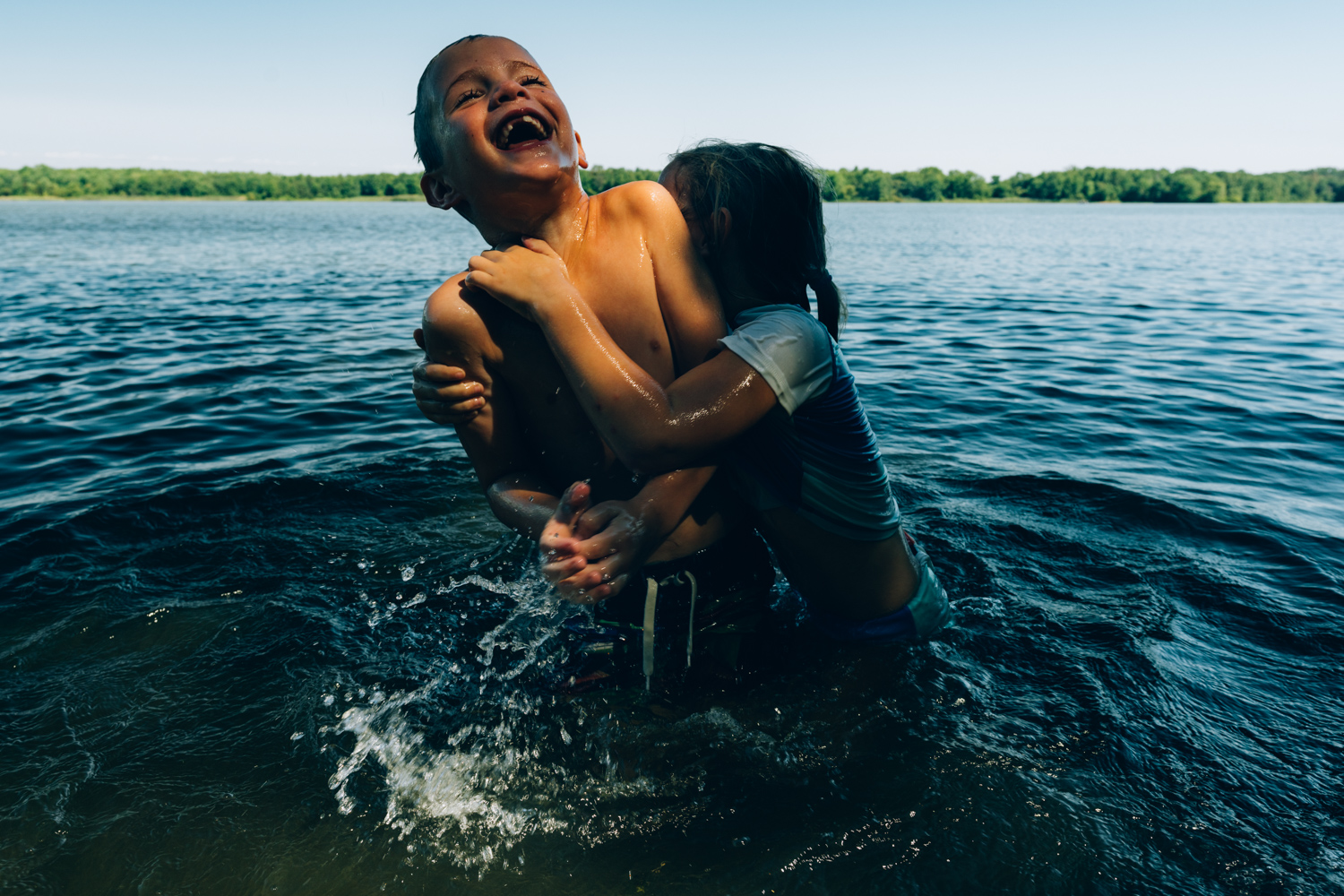 kids playing in a lake
